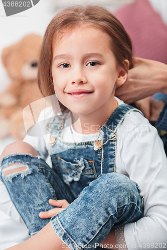 Image of A little cute girl enjoying, playing and creating with mother hands