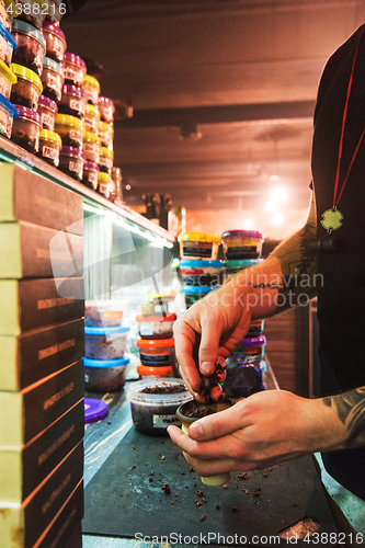 Image of Shisha hookah preparing by barman.