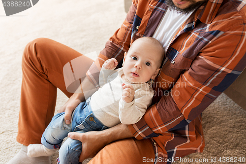 Image of happy father with little baby boy at home