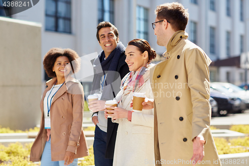 Image of office workers with coffee on city street