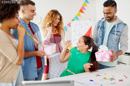 Image of team greeting colleague at office birthday party