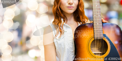 Image of close up of female musician with guitar