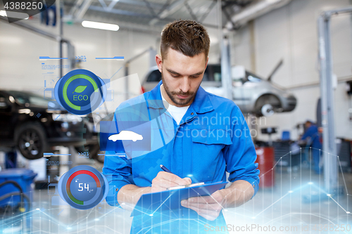 Image of auto mechanic man with clipboard at car workshop