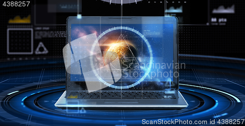 Image of laptop with virtual planet and space hologram