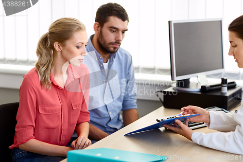 Image of couple visiting doctor at family planning clinic