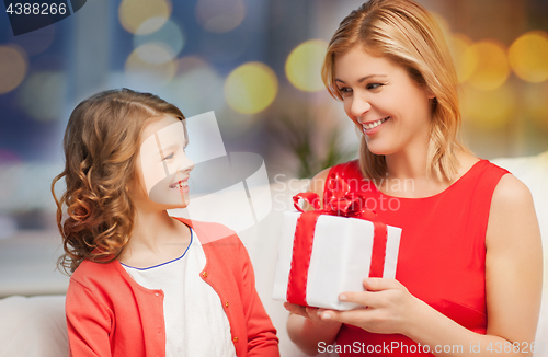 Image of happy mother and daughter with gift box