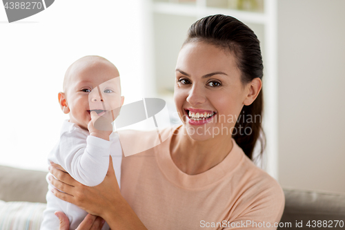 Image of happy mother with little baby boy at home