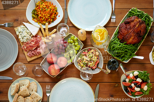 Image of various food on served wooden table