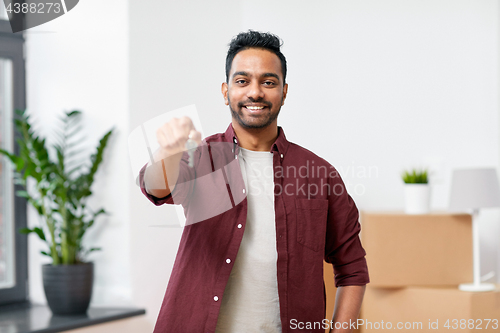 Image of happy man with key moving to new home