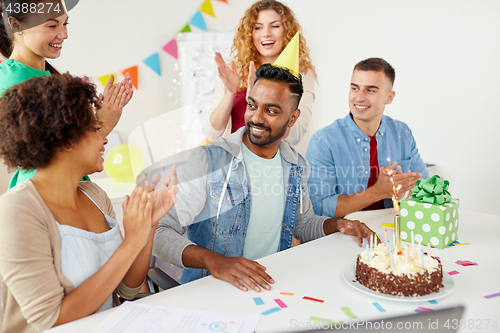 Image of office team greeting colleague at birthday party