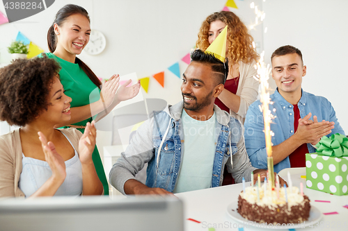 Image of office team greeting colleague at birthday party