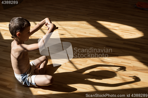 Image of Charming little boy  playing  in theatre of shadows