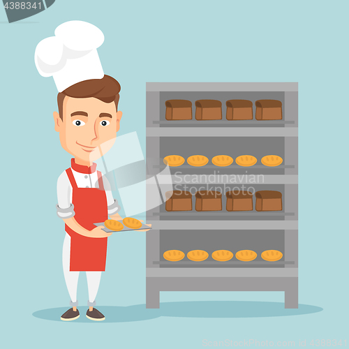 Image of Happy young male baker holding tray of bread.