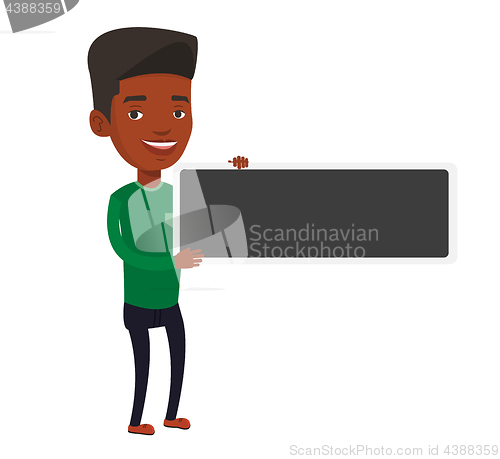 Image of Young african-american man holding blank board.