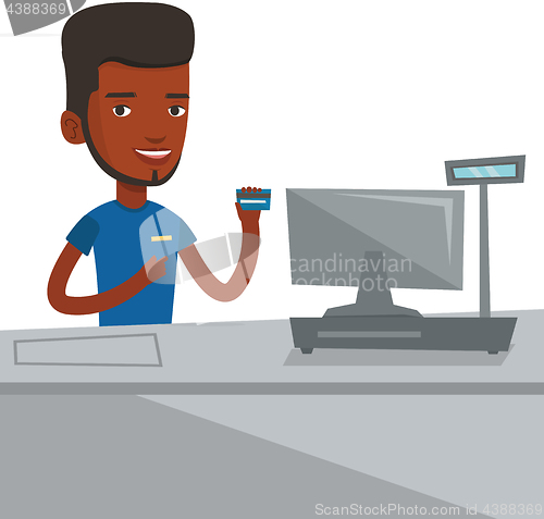 Image of Cashier holding credit card at the checkout.