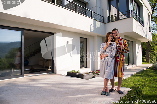 Image of Young beautiful couple in bathrobes