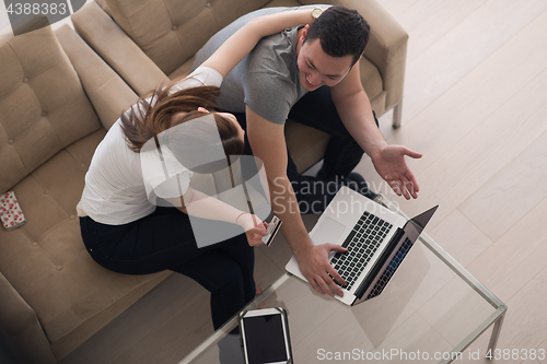 Image of happy young couple buying online