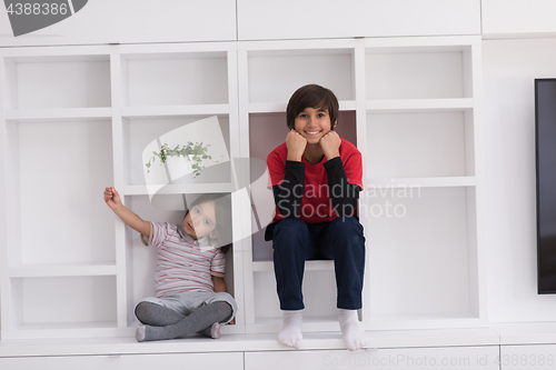 Image of young boys posing on a shelf