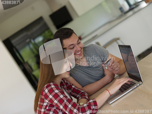 Image of happy young couple buying online