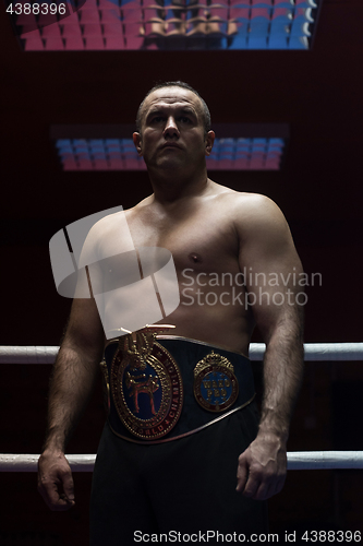 Image of kick boxer with his championship belt