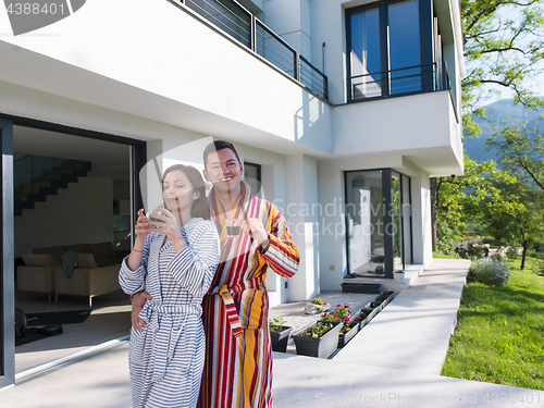 Image of Young beautiful couple in bathrobes