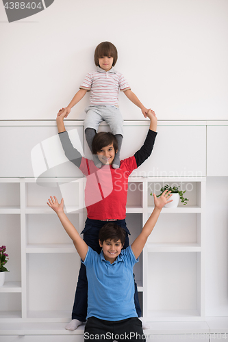 Image of young boys posing line up piggyback