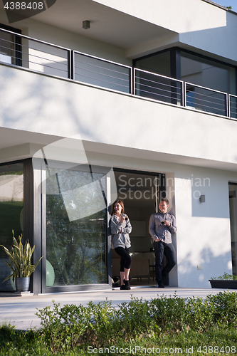 Image of couple enjoying on the door of their luxury home villa