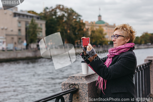 Image of Woman taking shots on waterfront