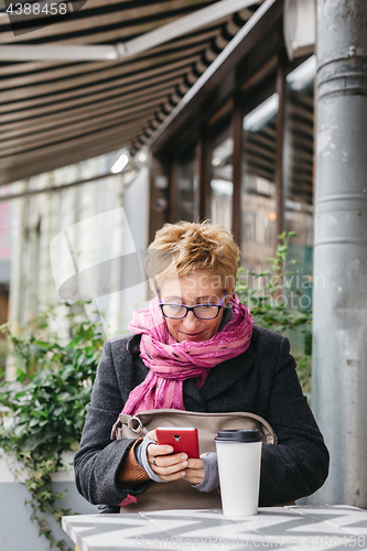 Image of Adult woman surfing phone