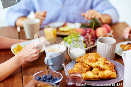 Image of close up of people eating food at table