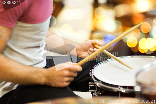 Image of close up of musician or drummer playing drum kit