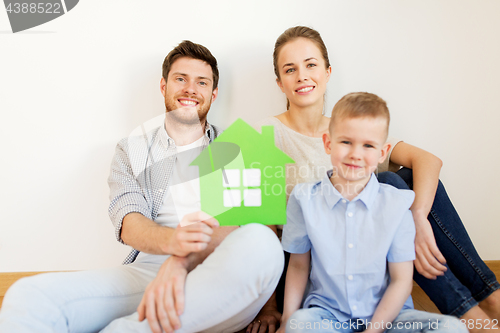 Image of happy family with green house moving to new home