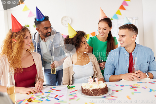 Image of team greeting colleague at office birthday party