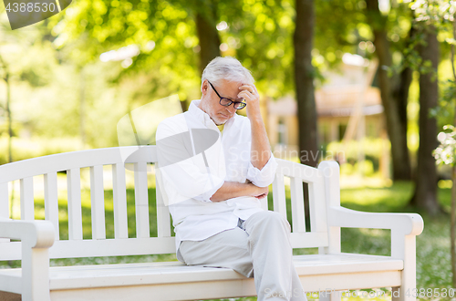 Image of thoughtful senior man at summer park