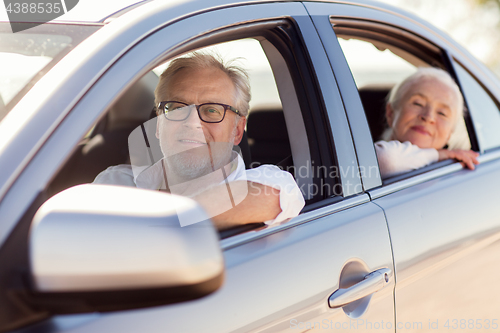 Image of happy senior couple driving in car