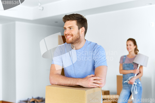 Image of happy couple with boxes moving to new home