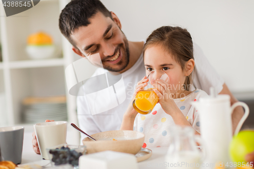 Image of happy family having breakfast at home