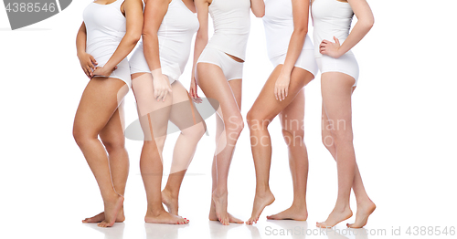 Image of group of happy diverse women in white underwear