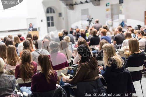 Image of Woman giving presentation in lecture hall at university.