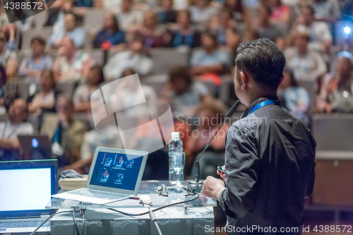 Image of Public speaker giving talk at Business Event.