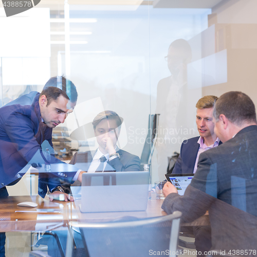 Image of Business people sitting and brainstorming at corporate meeting.