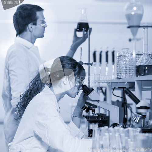 Image of Health care professionals microscoping in scientific laboratory.