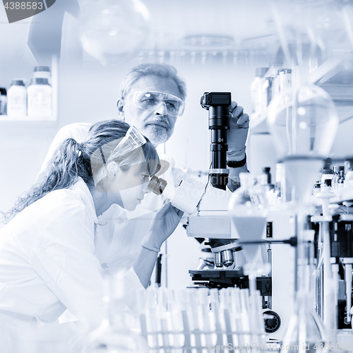 Image of Health care researchers microscoping in scientific laboratory.