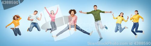 Image of happy people or friends jumping in air over blue