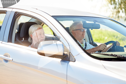 Image of happy senior couple driving in car