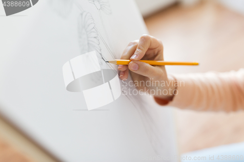 Image of artist with pencil drawing picture at art studio