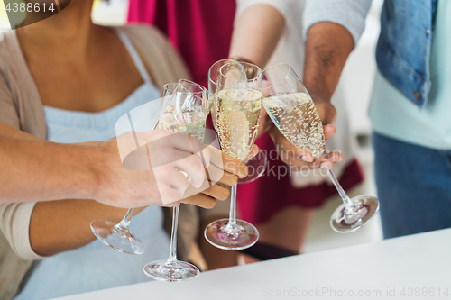 Image of friends clinking glasses of champagne at party