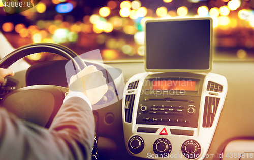 Image of close up of young man with tablet pc driving car