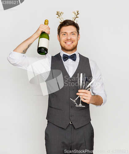 Image of man with bottle of champagne at christmas party