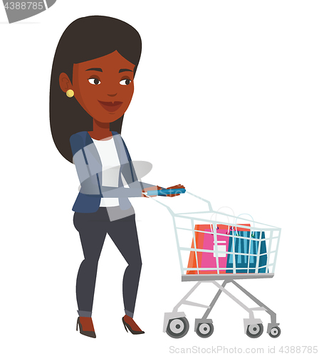 Image of African woman walking with shopping trolley.